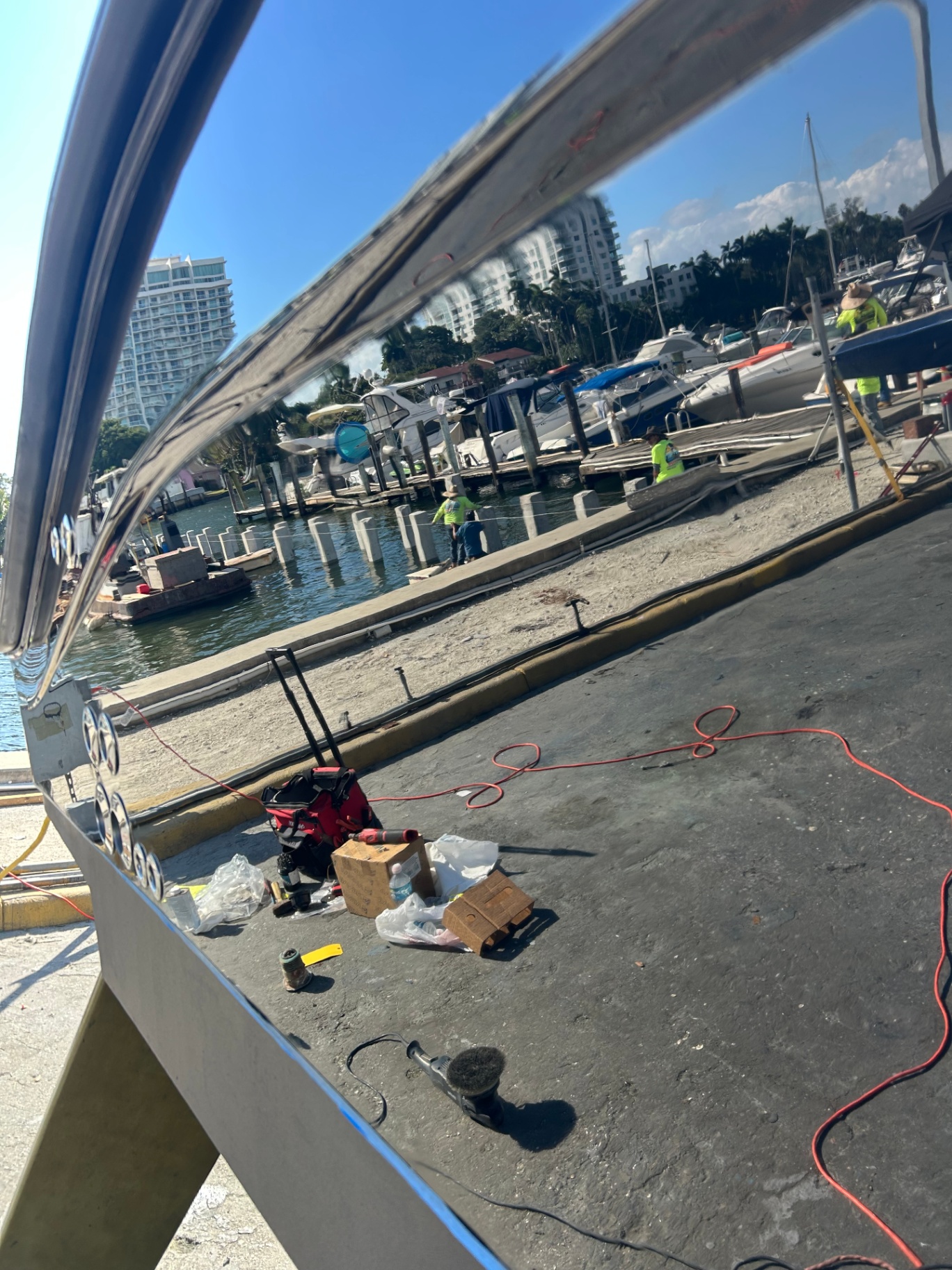 Polished aluminum surface reflecting a South Florida marina