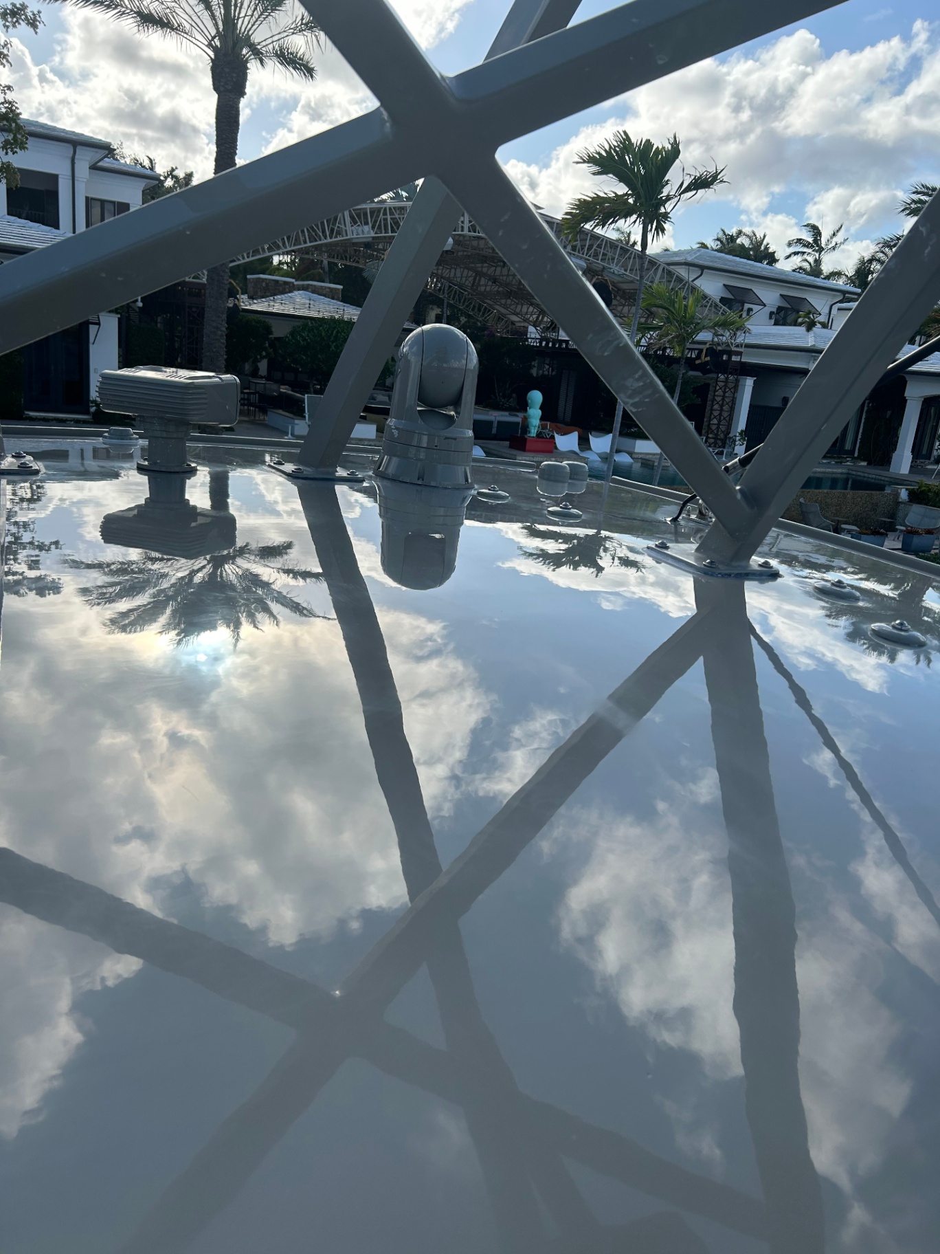 Mirror-finish hardtop reflecting palms and sky after ceramic coating